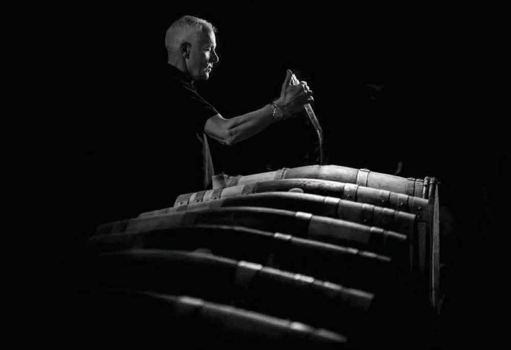 Plate VI — Topping up the barrels